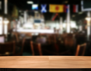 Wood table with blured background cafe , for your photo montage or product display. Space for placing items on the table.
