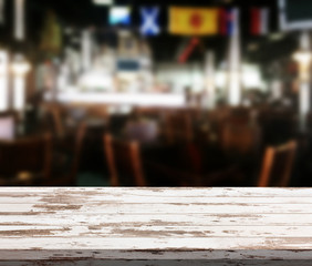 Wood table with blured background cafe , for your photo montage or product display. Space for placing items on the table.
