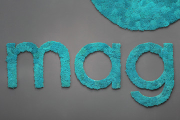 Word mag of cyan moss.On the grey wall.