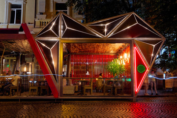Modern summer terrace of restaraunt, exterior. Futuristic, geometrical form. At night...