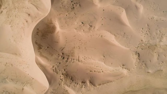 Panoramic movement in the sand.  Flight over the barkhans in the desert.