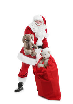 Authentic Santa Claus with red bag full of gifts on white background