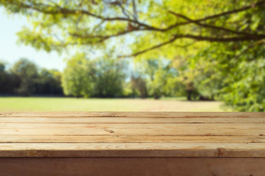Empty wooden table over autumn nature park background