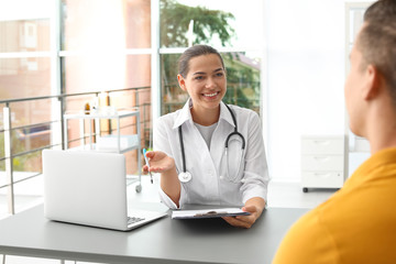 Doctor talking to her patient in hospital
