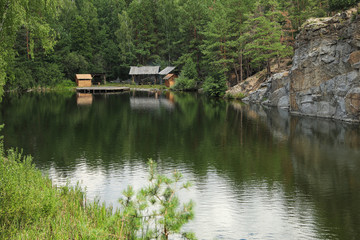 Beautiful landscape with forest and rocky mountain near lake. Camping season