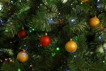 Obraz na płótnie Canvas Fir tree with festive decor and glowing Christmas lights as background