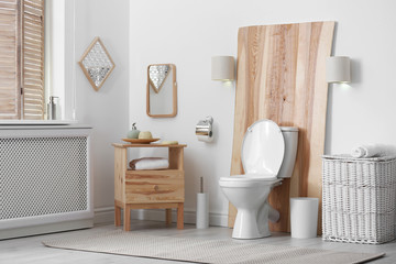 Toilet bowl in modern bathroom interior