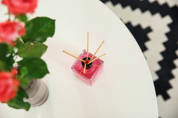 Aromatic reed air freshener on table indoors