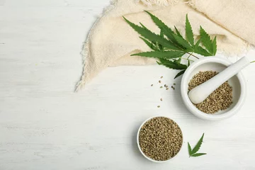 Poster Im Rahmen Flat lay composition with hemp seeds and space for text on wooden background © New Africa