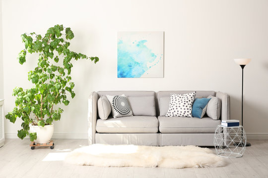 Stylish Room Interior With Large Houseplant And Couch