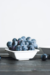 red grape juice in china bowl, black wood table background