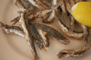 Fried anchovies and lemon slice