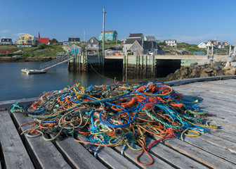 Colorful ropes on wooden pier in harbor at Peggy's Cove, Nova Scotia