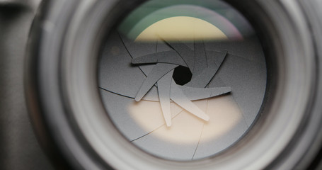 Closeup shot of professional camera lens, adjusting aperture