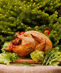 Baked turkey with cherry tomatoes on a Christmas background. Natural food cooked on the grill.