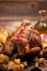 roasted chiken on wooden board with chips