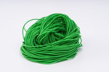 Rope, green rubber rope. Twisted rope beautifully on a white background.