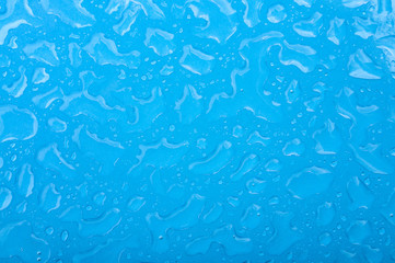 Abstract backgrounds and wallpapers concept with wet light blue background with focus on water drops and copy space