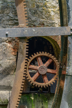 rusty water wheel gears on an old gristmill