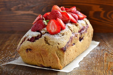 Strawberry cake with fresh berries, sprinkle with powdered sugar