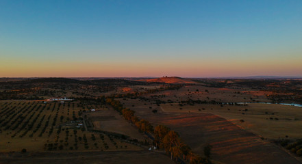 Aerial view from landscape with fields and a lake at the sunset. Drone photo