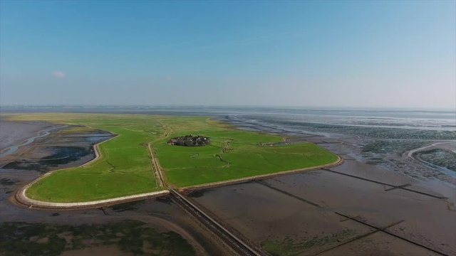 AERIAL: Hike to Halling Oland in the Wadden Sea on a sunny day