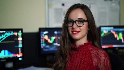 Financial advisor portrait on the background of monitors in company. Working process in office. World market and sales data. - Powered by Adobe