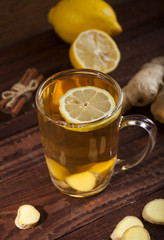 Ginger tea with lemon on wooden background