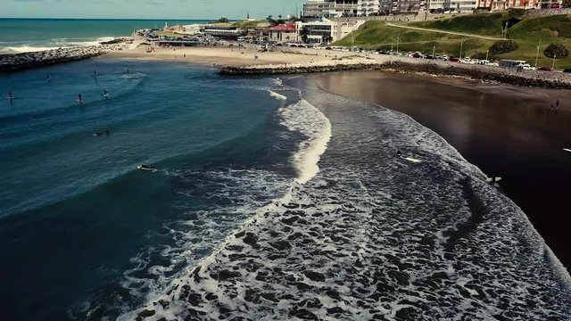 SUP Paddleboard at Playa Varese on the coast of Mar del Plata Argentina – 4k drone video of the Argentinian coast Mar del Plata Casino Central in spring.  Buenos Aires Capital Federal district  