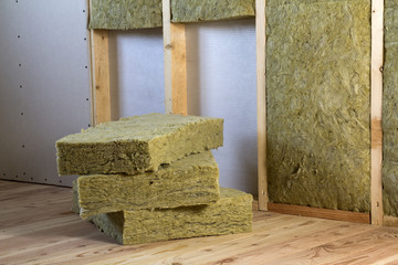 Wooden frame for future walls with drywall plates insulated with rock wool and fiberglass...