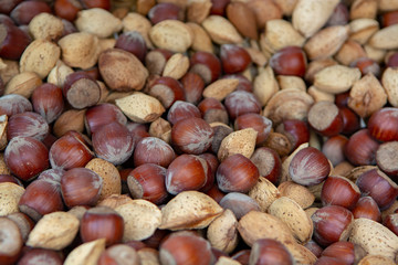Food background with new harvest of nuts, almonds and hazelnuts in shell