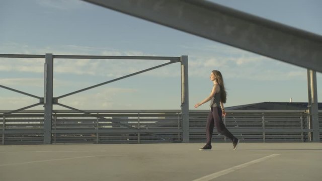 young  girl dancer performs a pirouettes and freestyle moves on a concrete rooftop