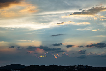 afternoon sky golden hour light behind the clouds