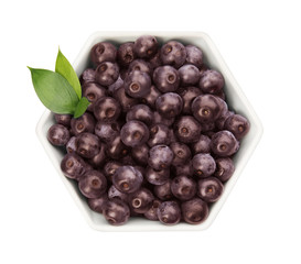Bowl with fresh acai berries on white background