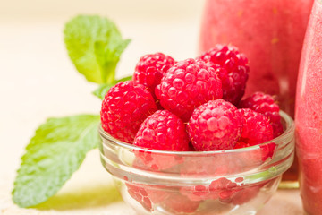 Raspberry smoothie close up photography with fresh summer blended cocktail and ripe berries.