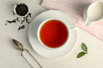 Flat lay composition with delicious tea on wooden background