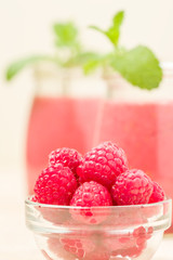Raspberry smoothie close up photography with fresh summer blended cocktail and ripe berries.