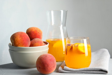 Tasty peach cocktail on table. Refreshing drink