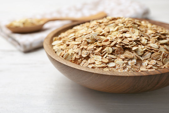 Bowl with oatmeal on wooden table. Grains and cereals