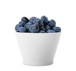 Bowl full of fresh ripe blueberries on white background