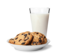 Plate with chocolate chip cookies and glass of milk on white background