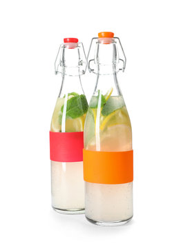 Bottles with natural lemonade on white background