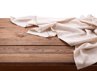 White table cloth on wooden table isolated. Napkin close up top view mock up