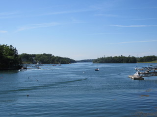 View over the water at Boothbay Harbor in Maine with boats and buoys 