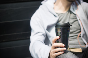 Close up of man with takeaway coffee.