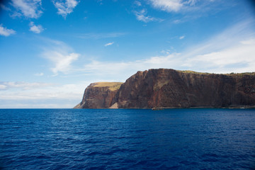 Fototapeta na wymiar Cliffs on the island of Lanai, Hawaii, as seen from a boat on a clear sunny day