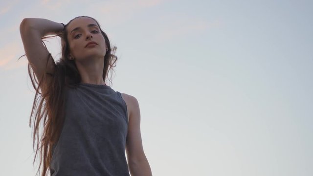 Young hip hop Girl with long hair turns at teh camera