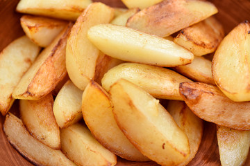 Fried potatoes in a plate. Junk food. Golden fries.