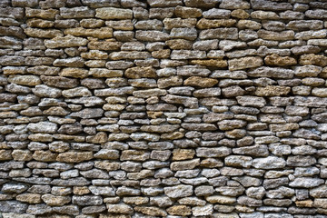 background of limestone walls, densely piled stones
