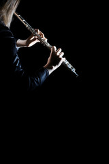 Flute instrument. Flutist hands playing flute isolated on black